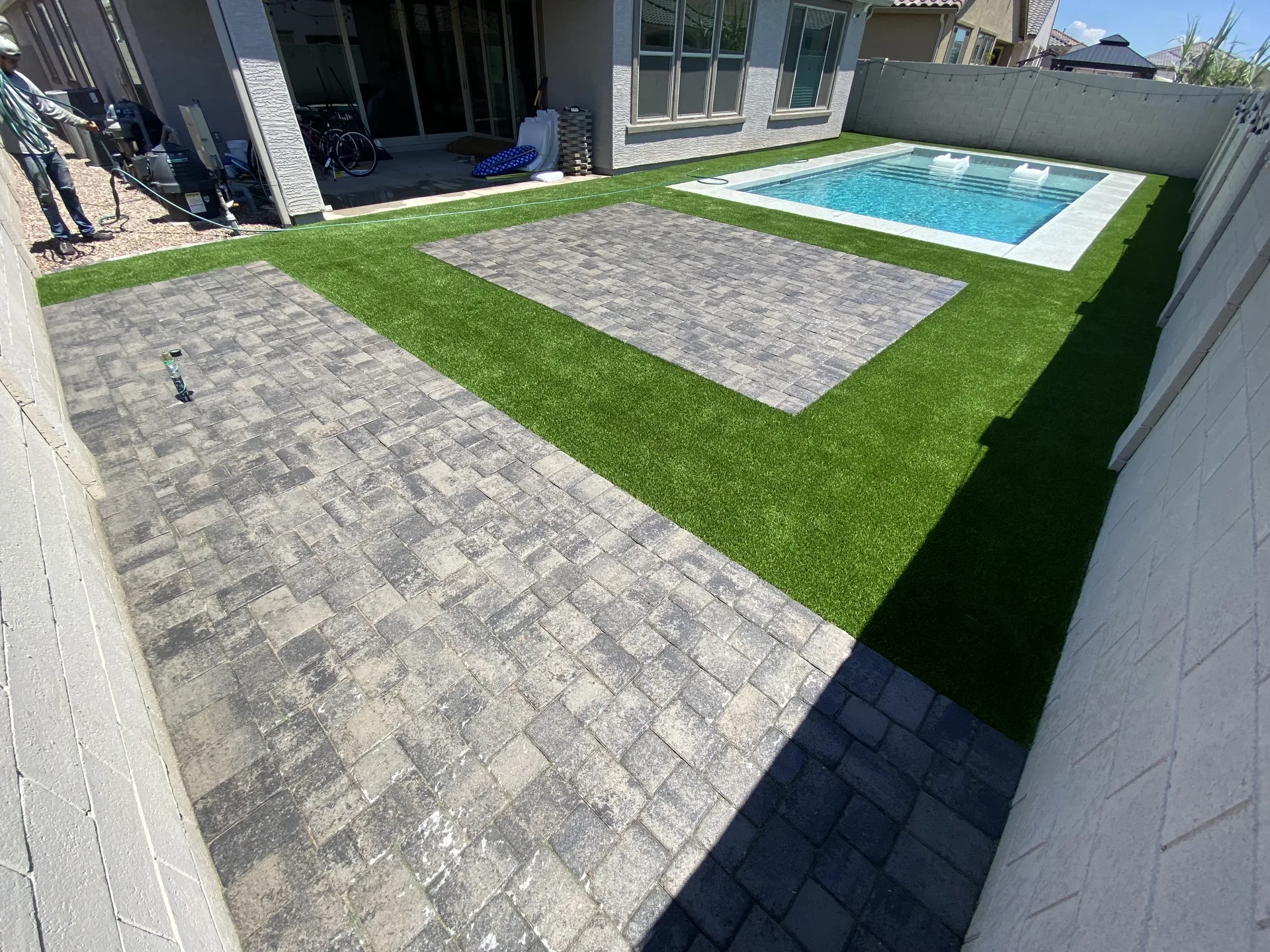 Backyard pavers, turf, and pool